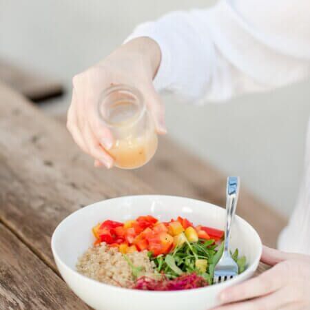 Food allergy travel agent eating a allergy friendly meal of fresh vegetables and rice.